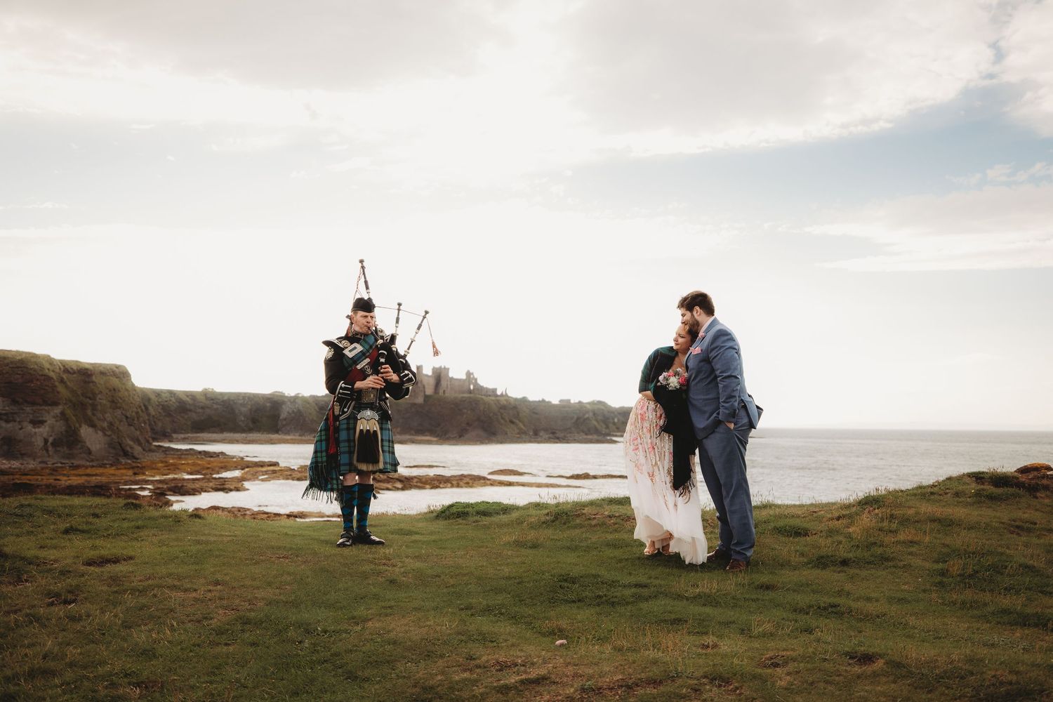 A romantic wedding photo featuring a beautiful bouquet with pink and white flowers against formal attire.