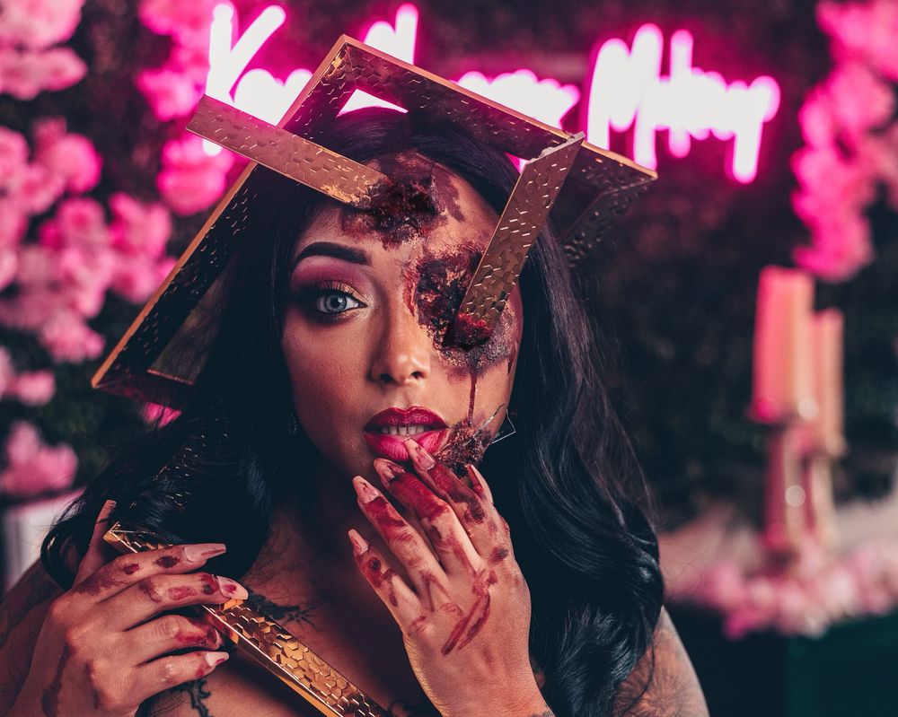 Creative Halloween makeup featuring glass prosthetics, dramatic beauty styling, and special effects artistry.