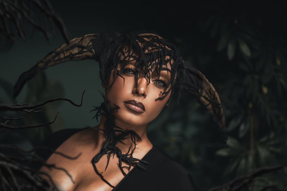 Creative beauty makeup with artistic black textures, dramatic lighting, and editorial makeup design.