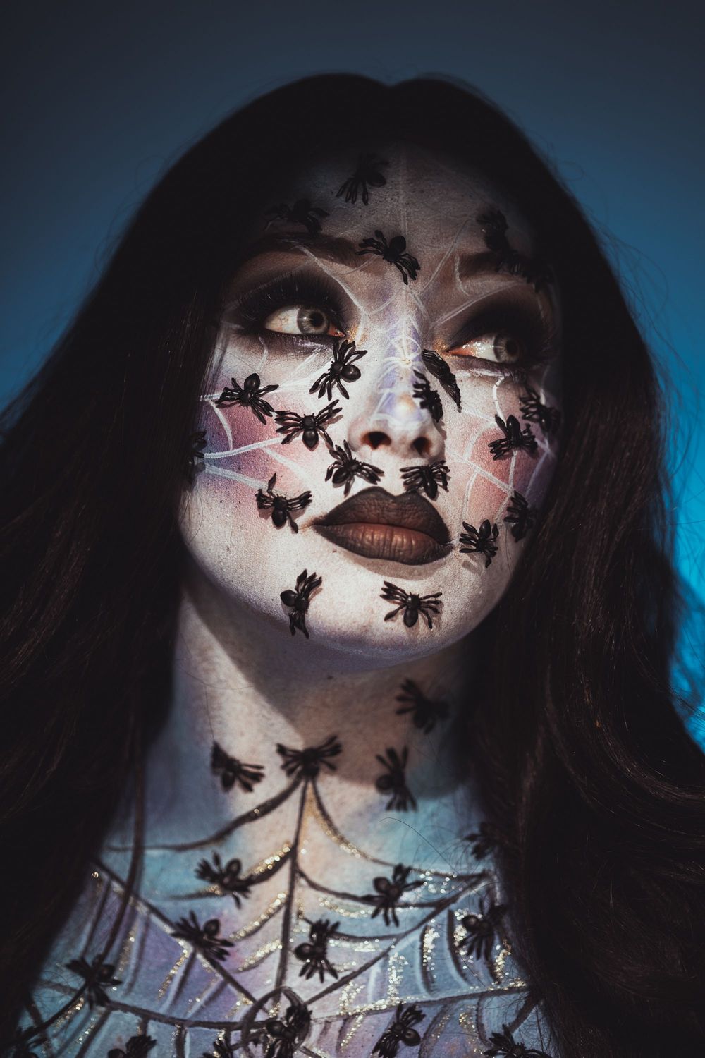 Sugar skull inspired makeup featuring intricate face painting and artistic special effects details.