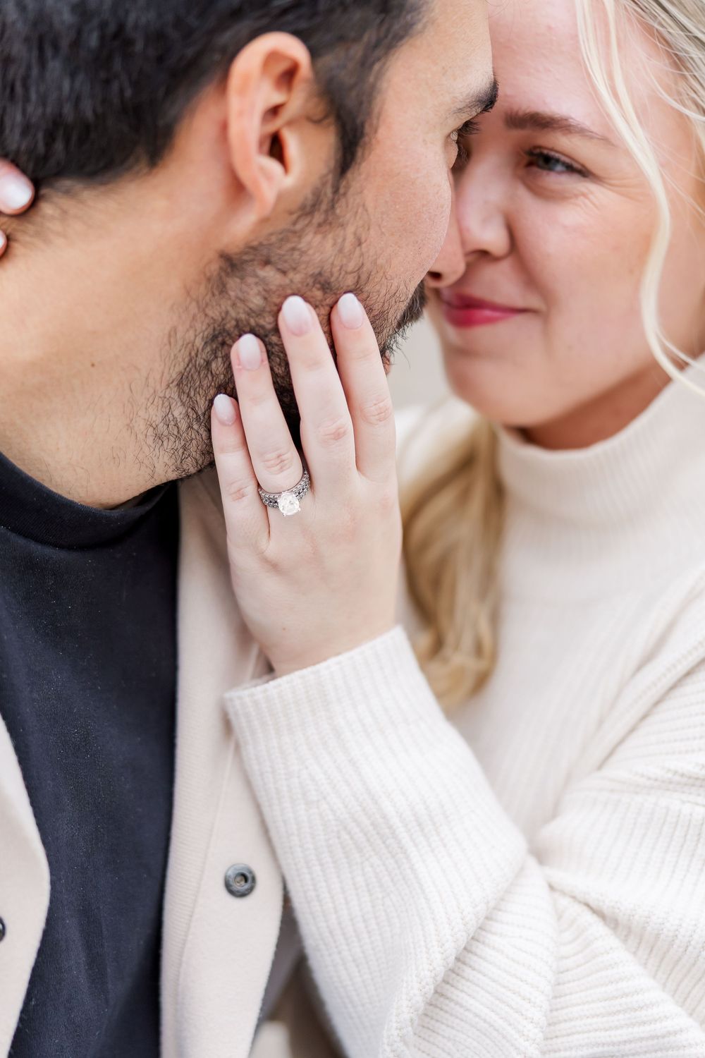 A romantic couple in white and black clothing share an intimate moment in a series of close-up photographs.