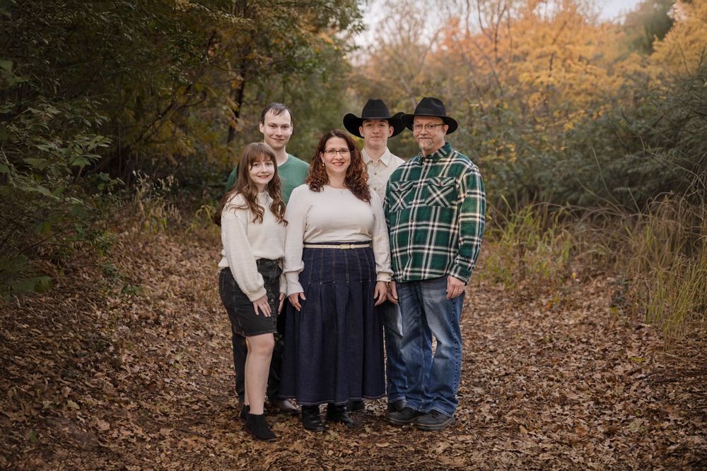 A family poses in the park.