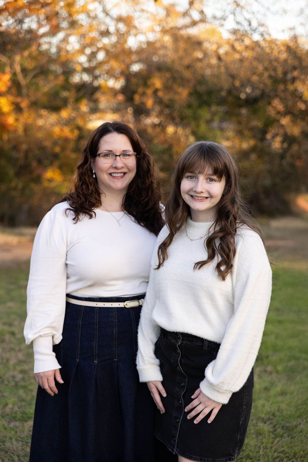 A Mom poses with her daughter in the park.