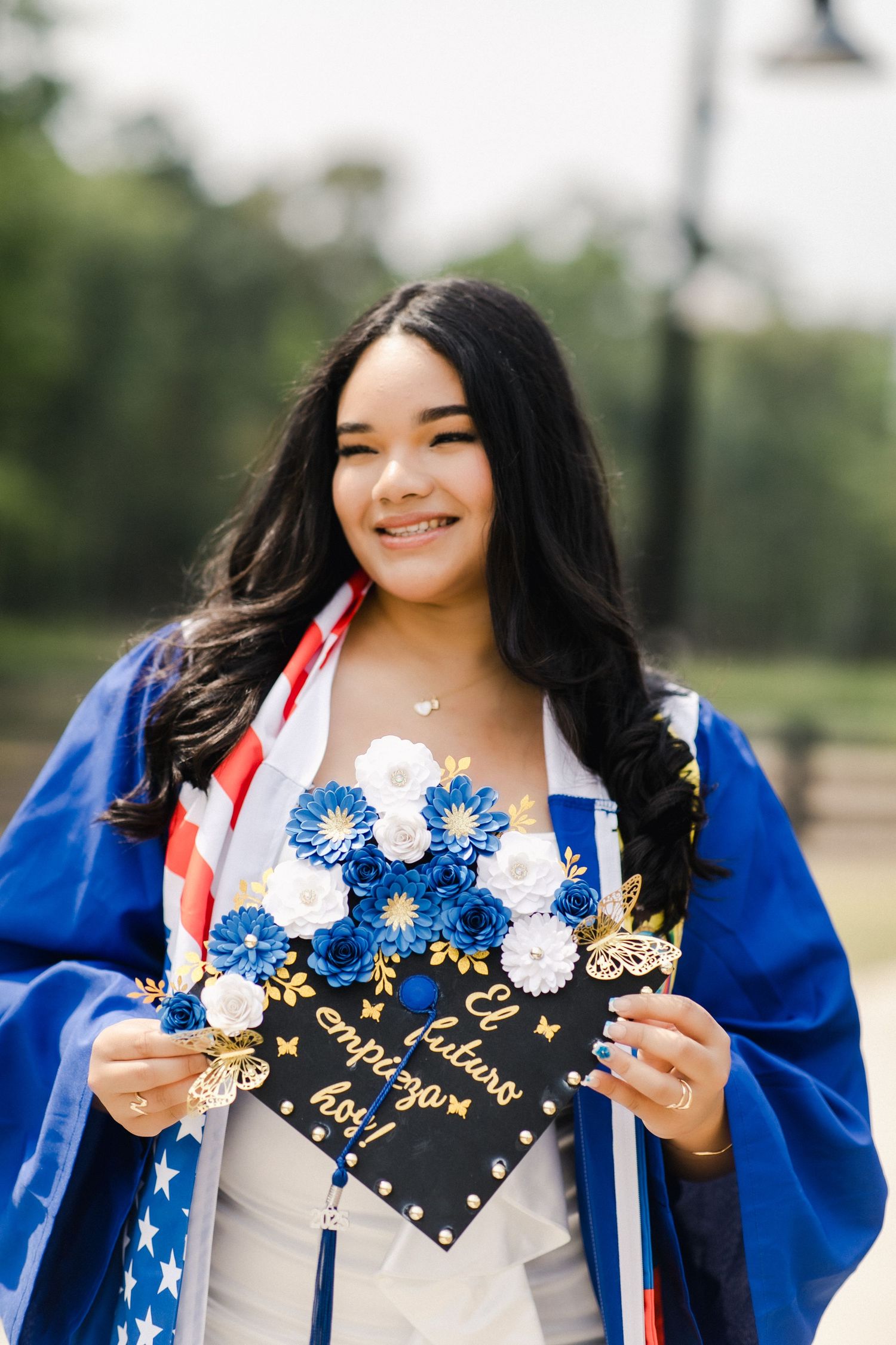A May River High graduation photo series showing a decorated mortarboard cap with blue and white decorations in Bluffton, SC park.