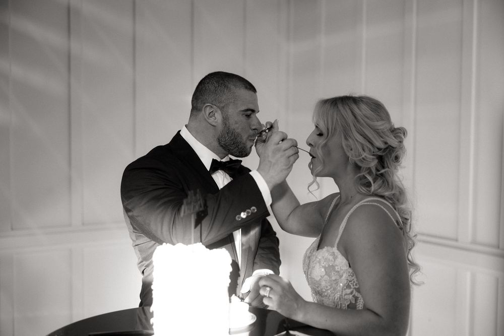 Black and white images showing romantic moments between a couple at their wedding celebration.