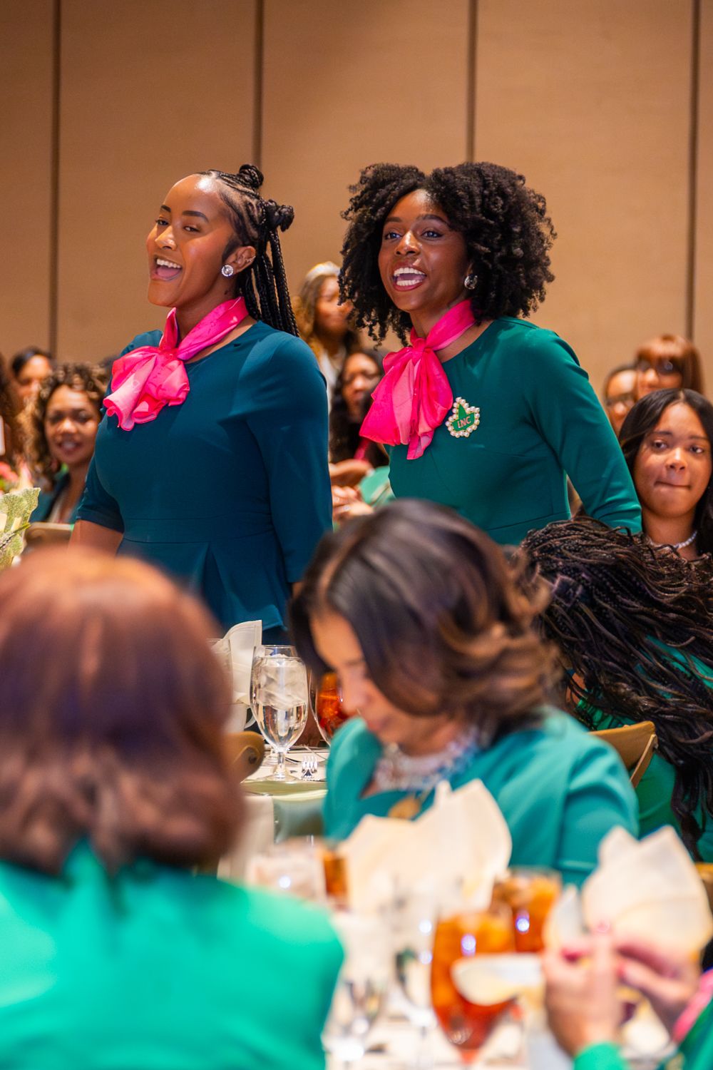 Two undergraduate students stand in recognition of their undergraduate chapter of Alpha Kappa Alpha Sorority, Incorporated.