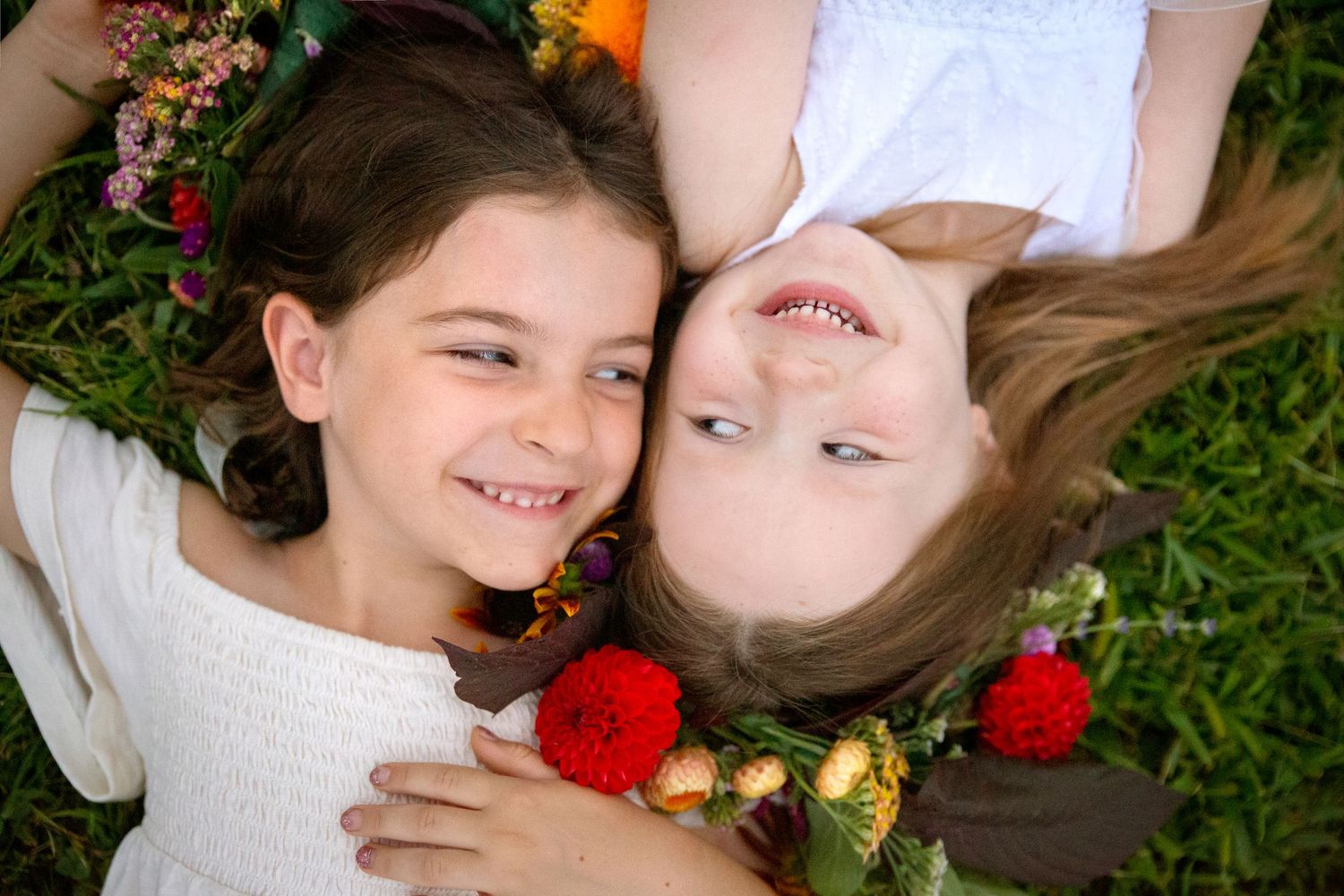 Kate Moonan's daughter laying her with friend while wearing a flower crown by Peace and Petal in Pittsburgh PA