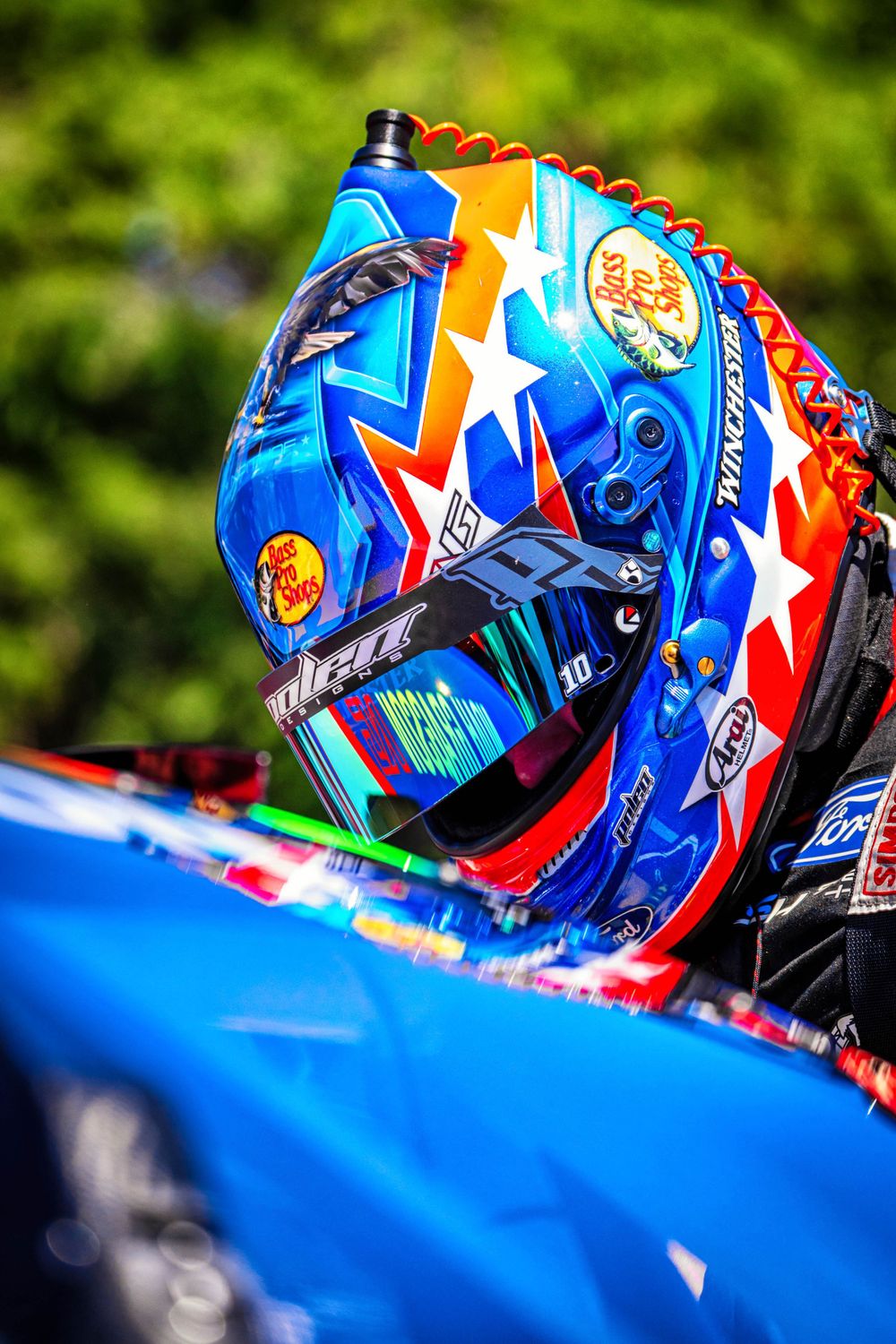 Colorful racing helmet with patriotic star design shown in close-up detail.