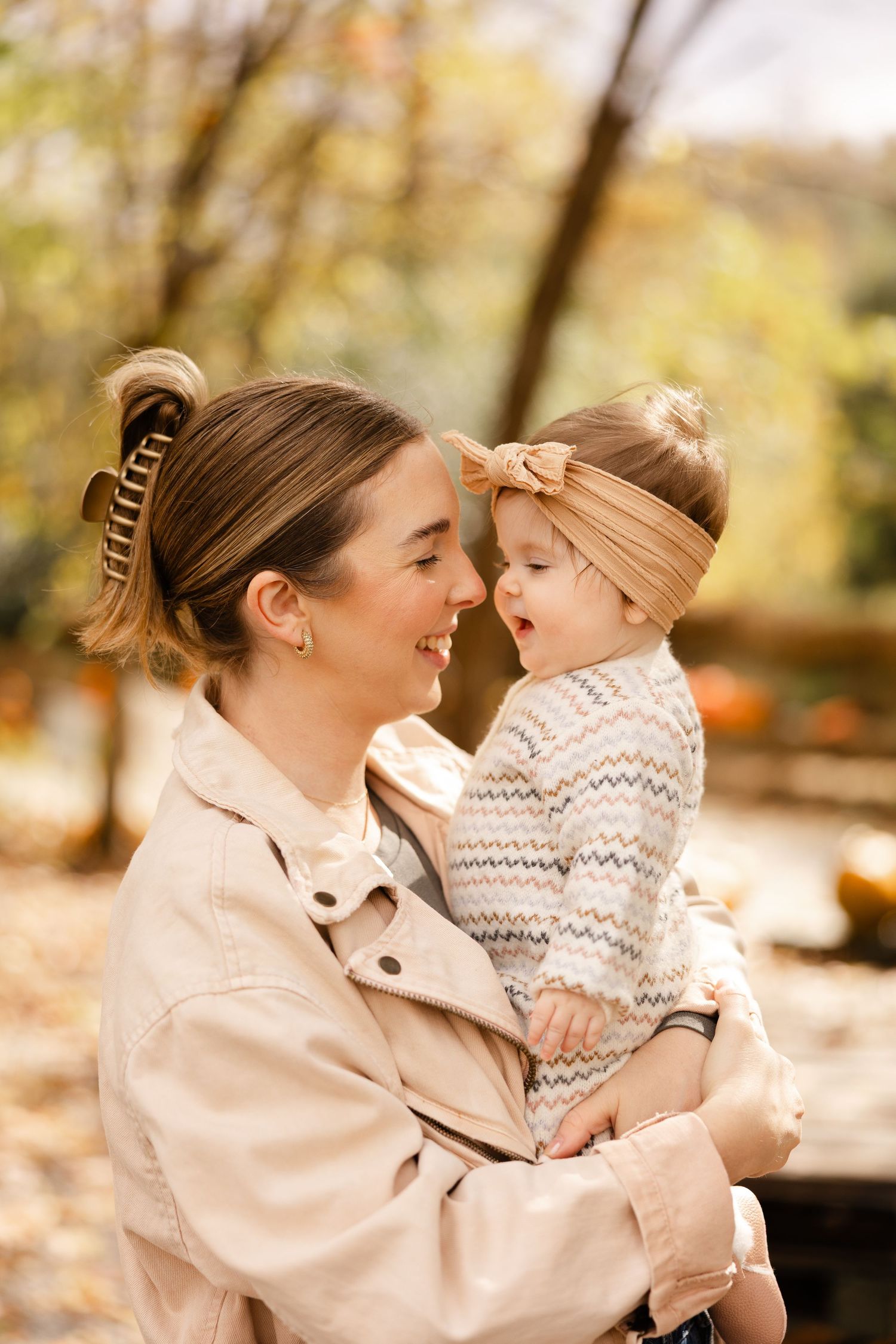 A parent and child share joyful moments together in a series of outdoor autumn photos with warm lighting.