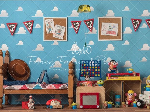 Toy Story themed photography backdrop featuring clouds, pennant banner, wooden bench, and colorful toys on blue background.