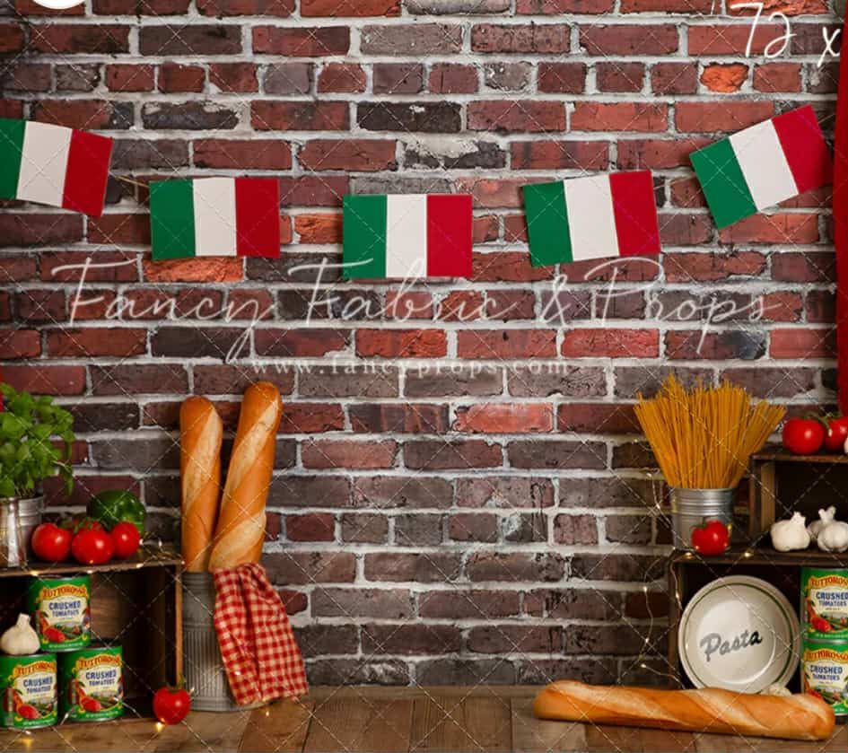 Italian restaurant decor with brick wall, hanging flags, bread loaves, and red checkered tablecloths creates rustic ambiance.