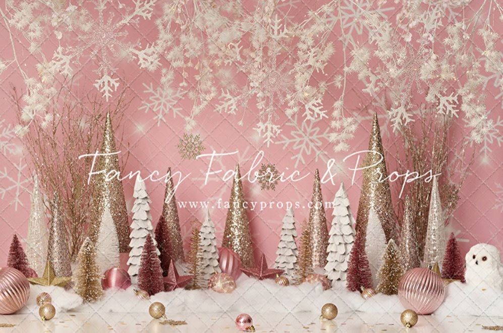 Enchanting winter forest backdrop in blush pink with snowy trees, snowflakes, and woodland creatures for holiday photos.