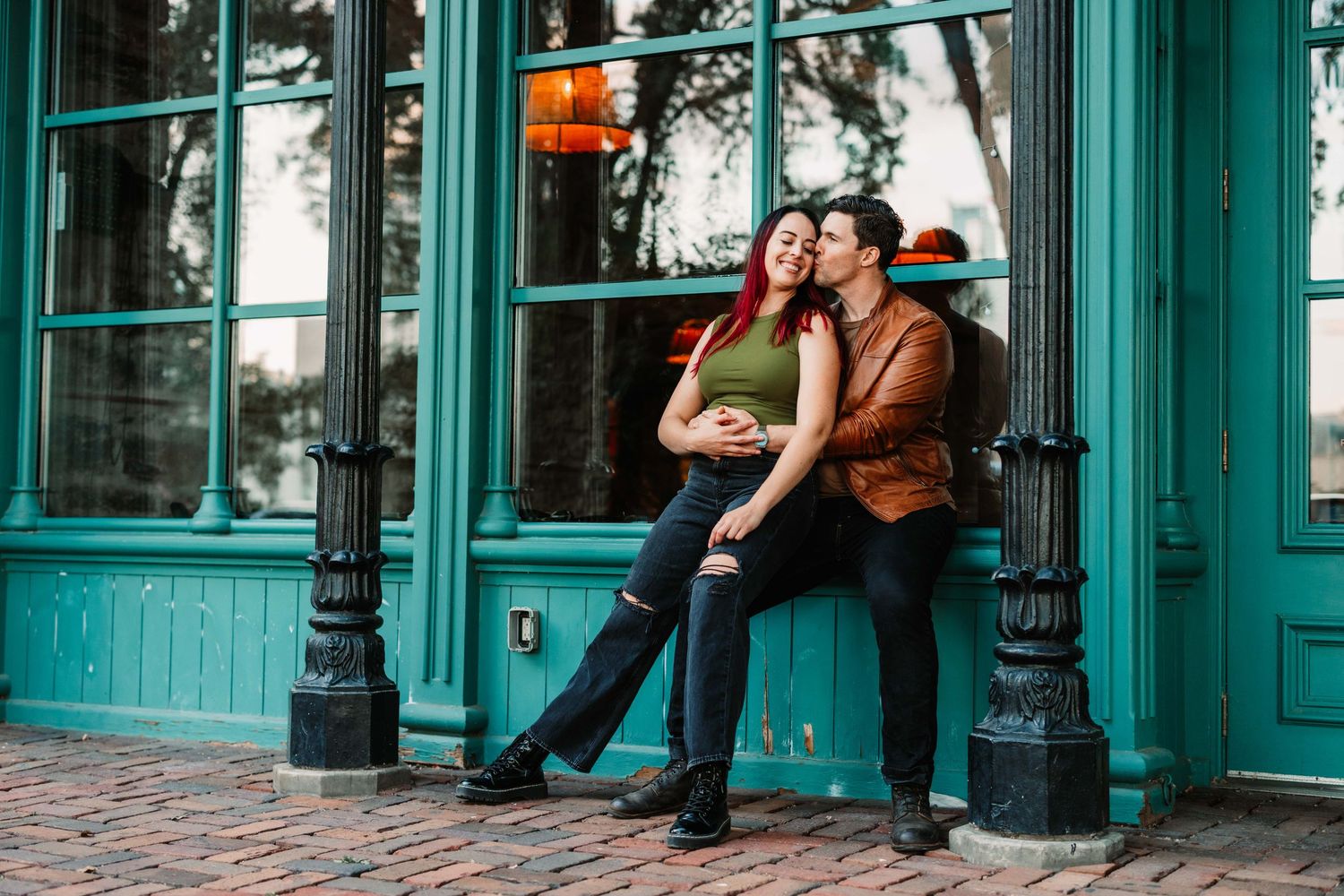 Romantic couple embracing outside modern glass building architecture.