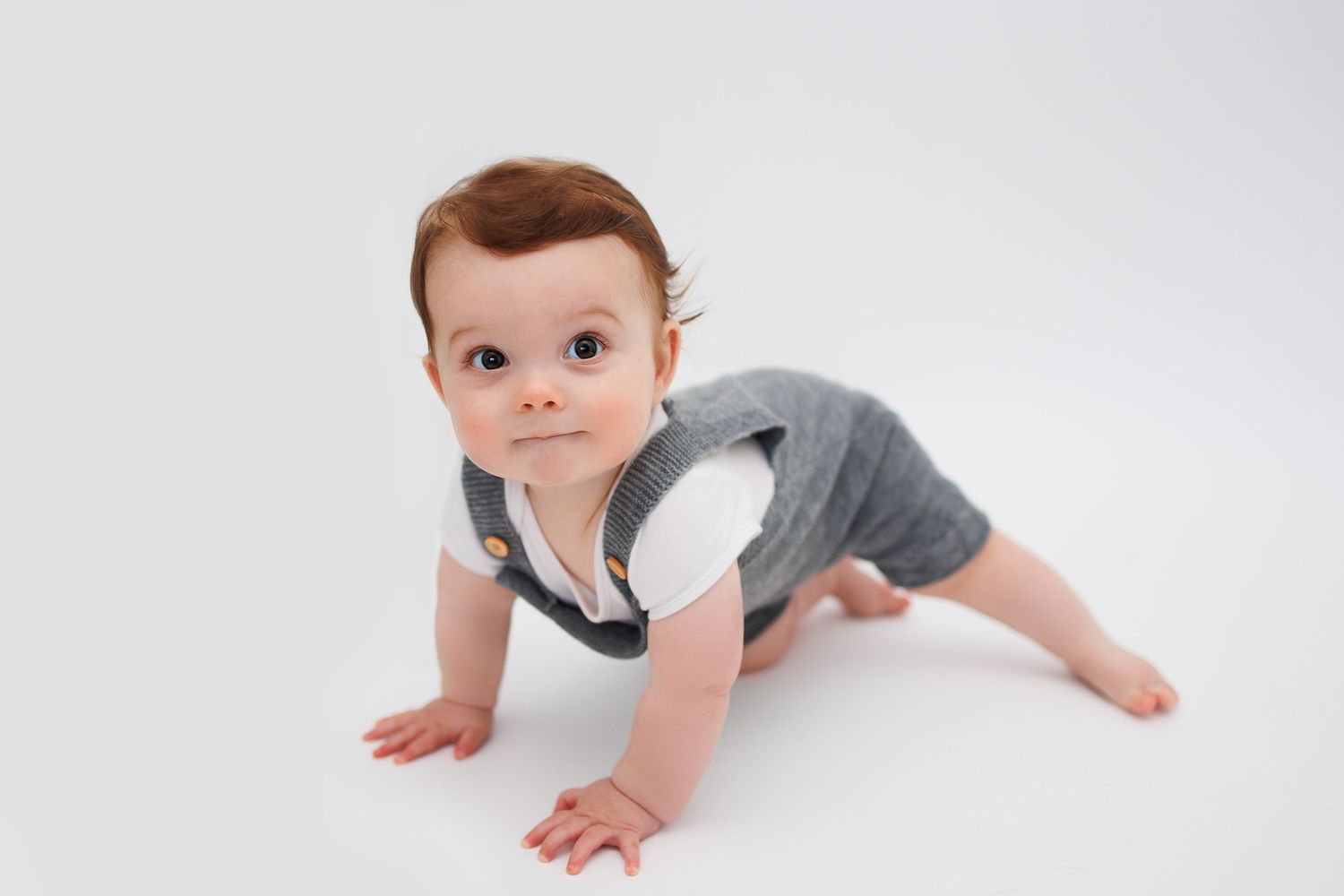 baby boy sitting unaided crawling white background grey outfit Tameside