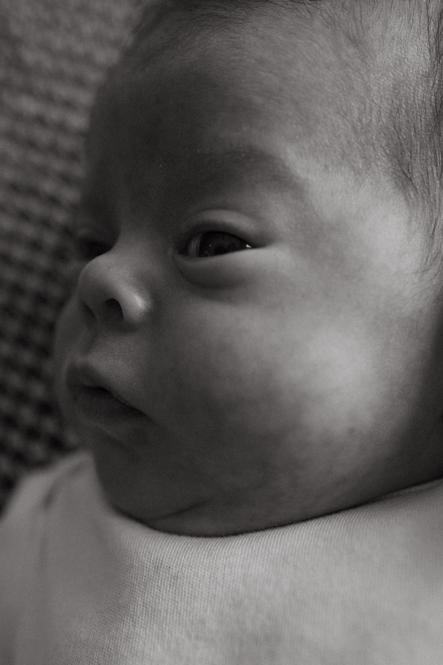 Black and white profile views of a sleeping newborn's peaceful face.