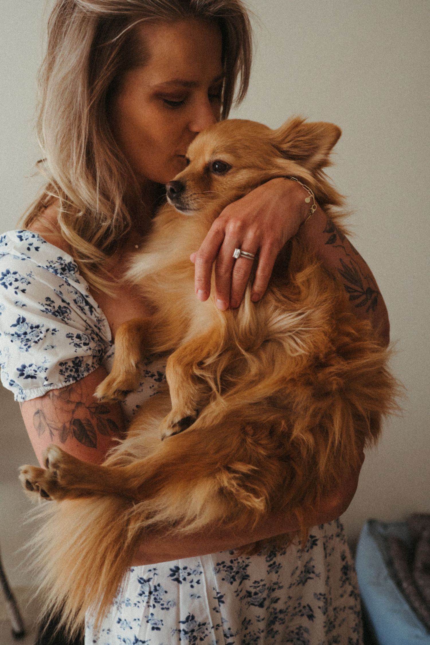 Person cuddling with golden retriever dog in intimate portrait series.