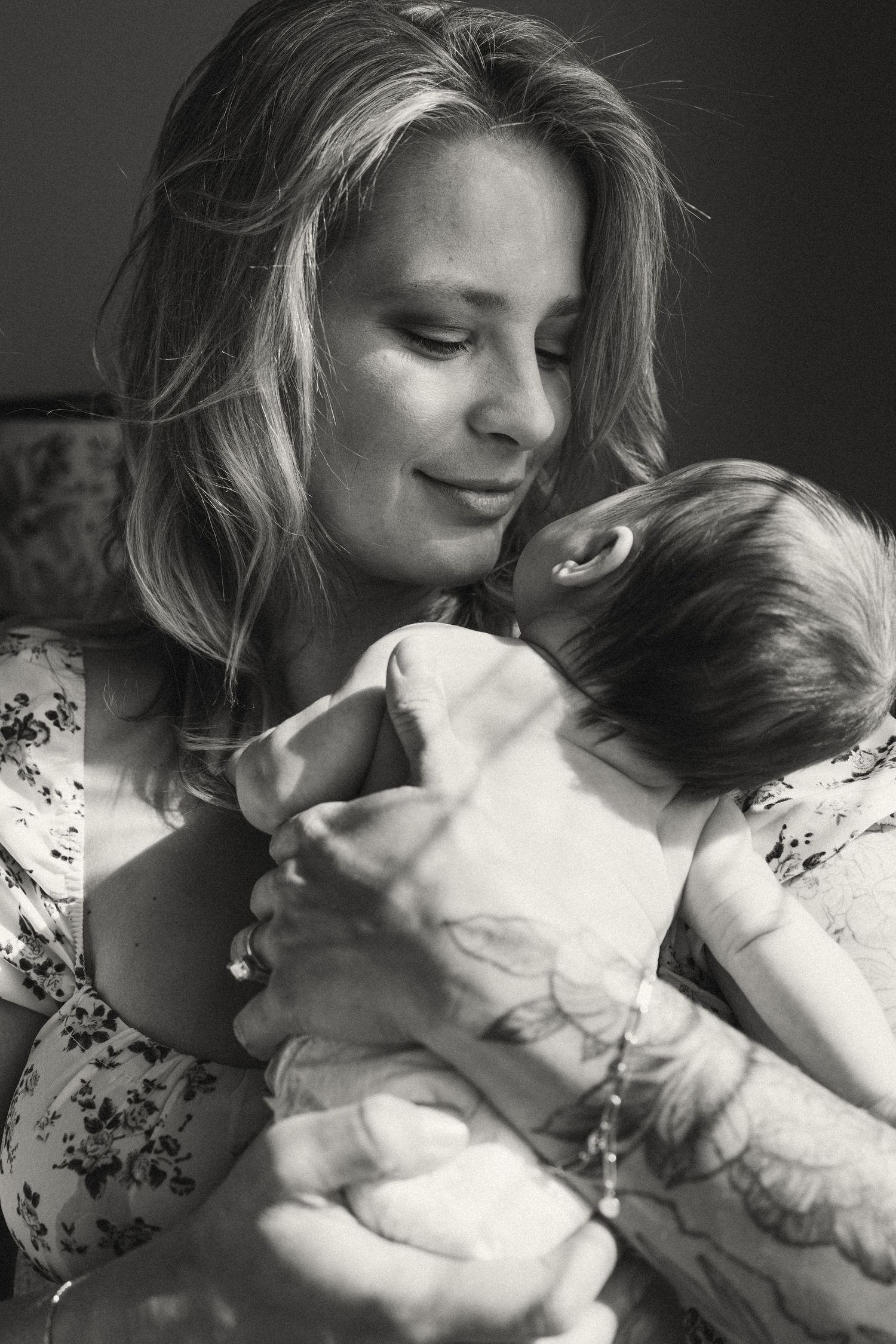 Intimate black and white portrait series showing tender moments and gentle expressions.