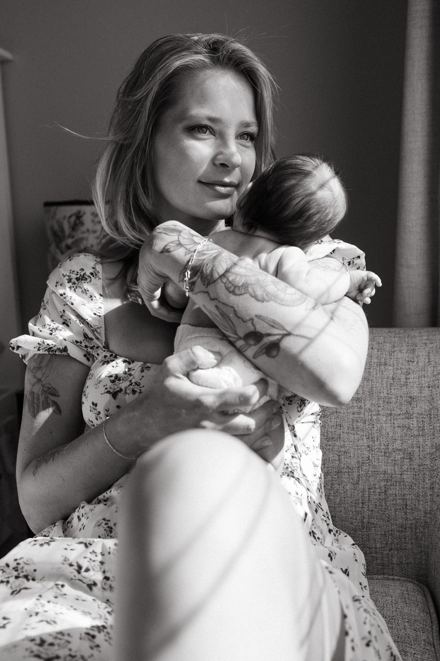 Artistic series of photographs showing gentle moments on a gray couch in natural window light.