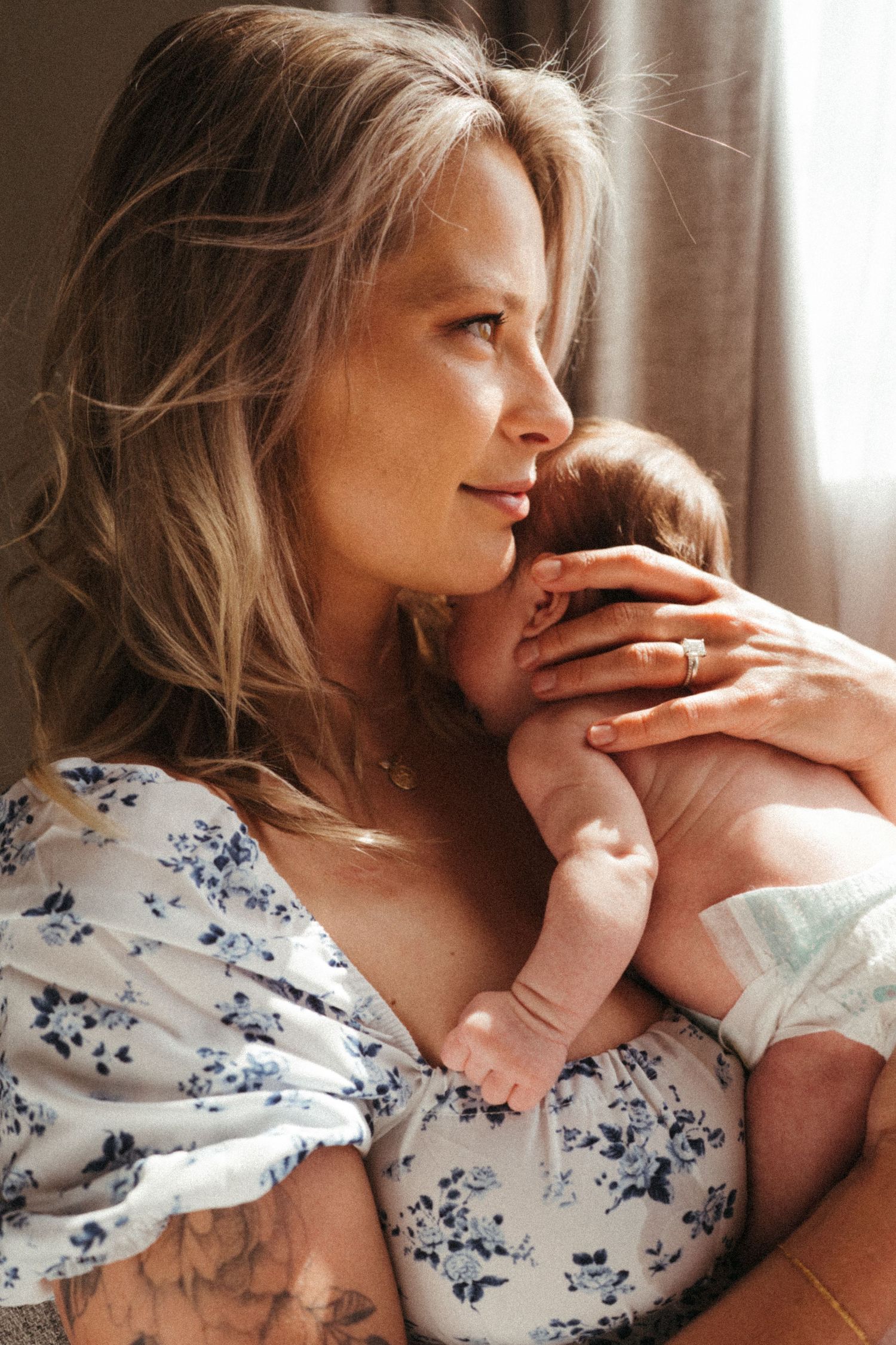 Intimate portrait series showing gentle moments in a floral patterned dress.