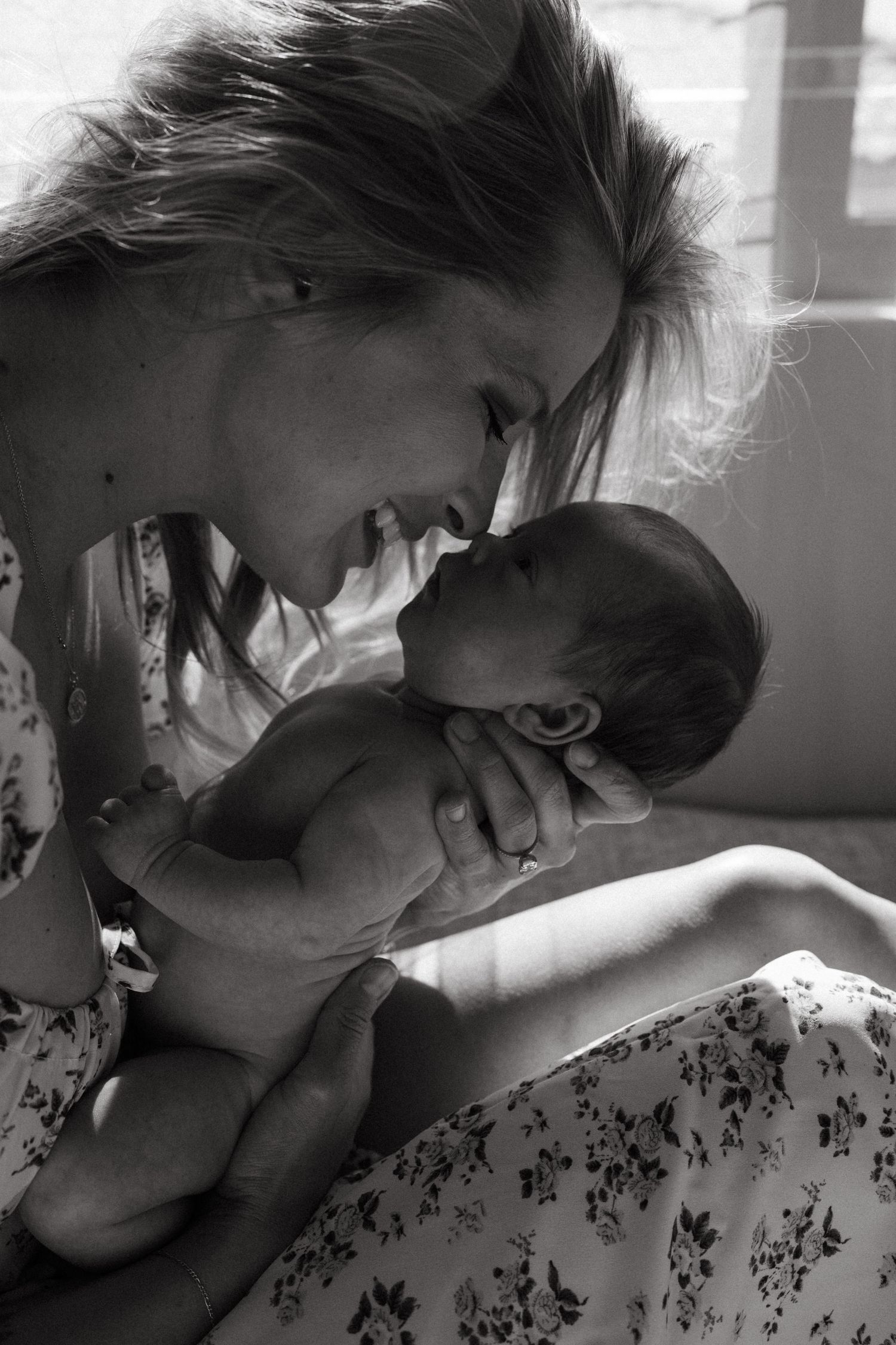 Black and white series capturing tender moments in natural window light.