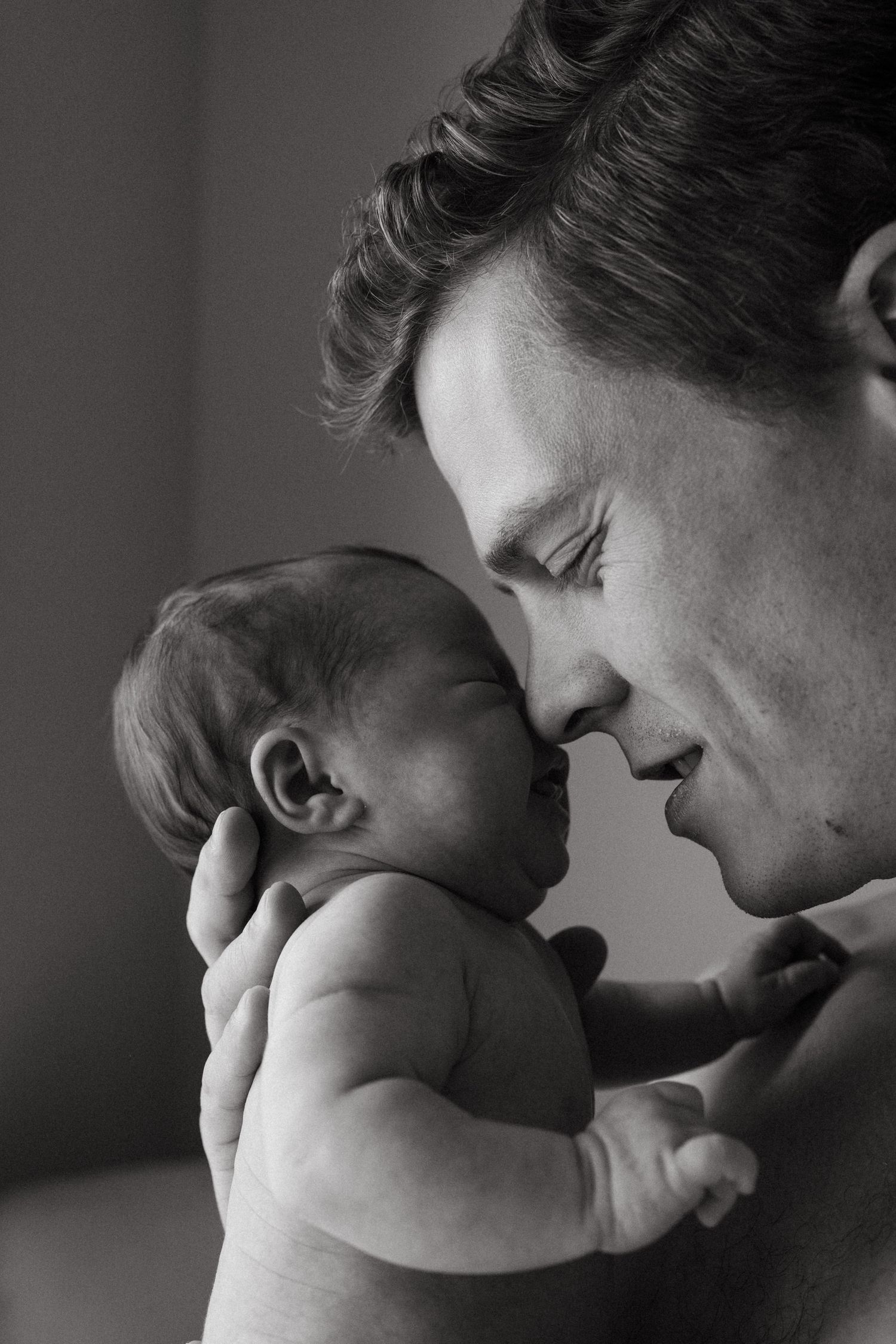 Black and white sequence showing intimate parent-child bonding moments.
