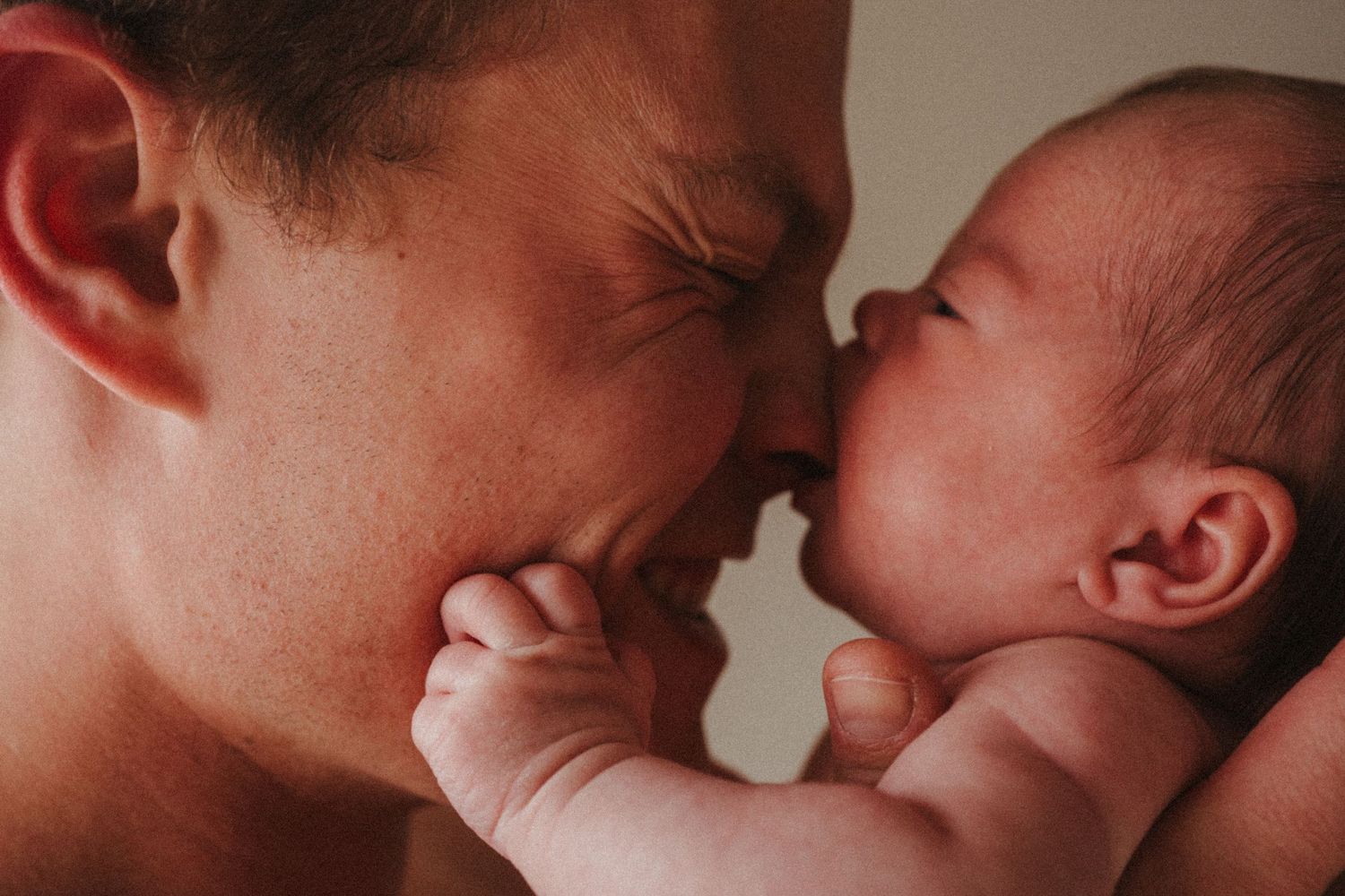 Warm-toned sequence capturing intimate bonding moments with a baby.