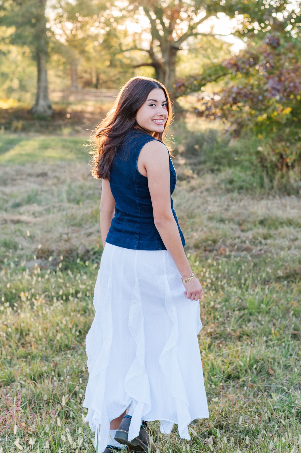 Senior girl walking on farm, Sharpsburg, GA