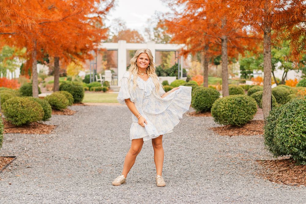 Senior girl in dress surrounded by orange trees, Trilith Fayetteville, GA