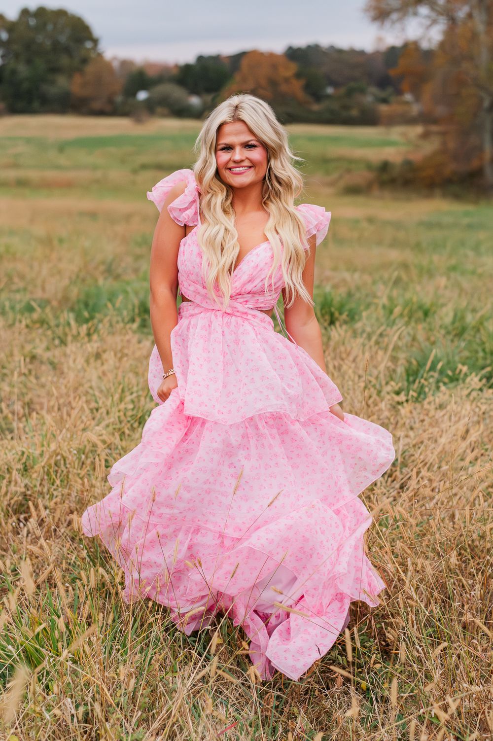 Senior girl in pink dress dancing in a field, Tyrone, GA