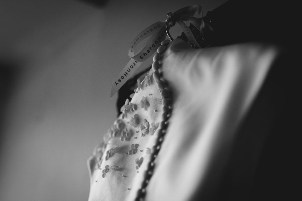 Black and white detail shot of a sparkling engagement ring with dramatic lighting and shadows.
