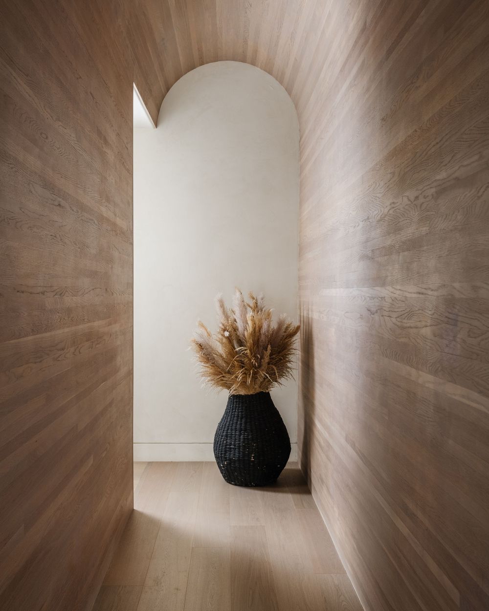 Arched hallway clad in wood