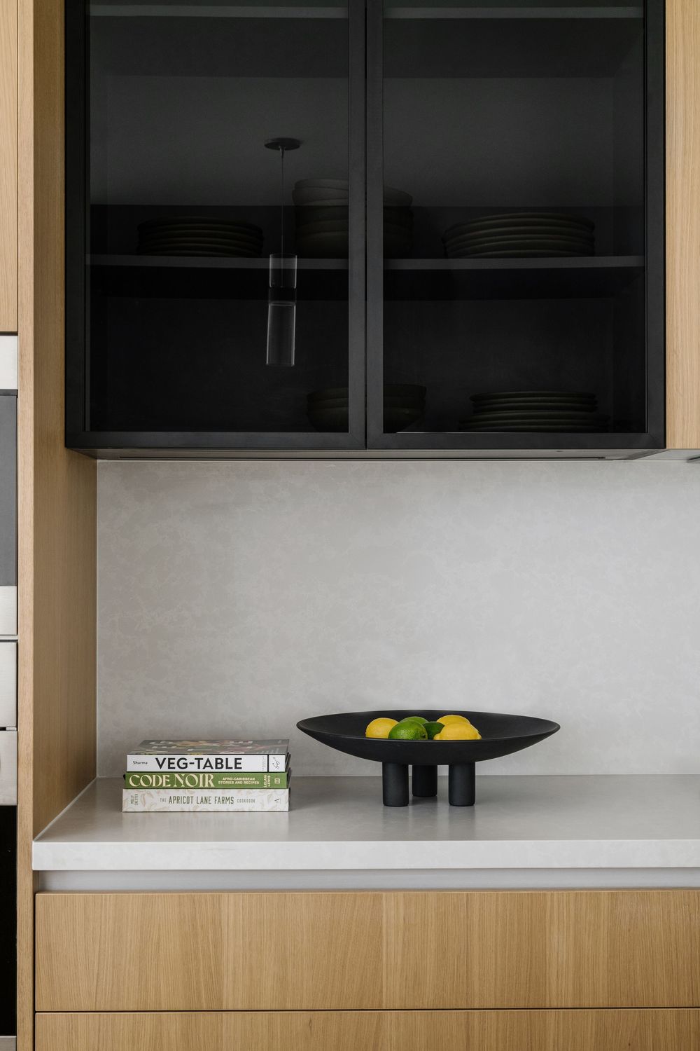 White oak and black glass kitchen cabinets