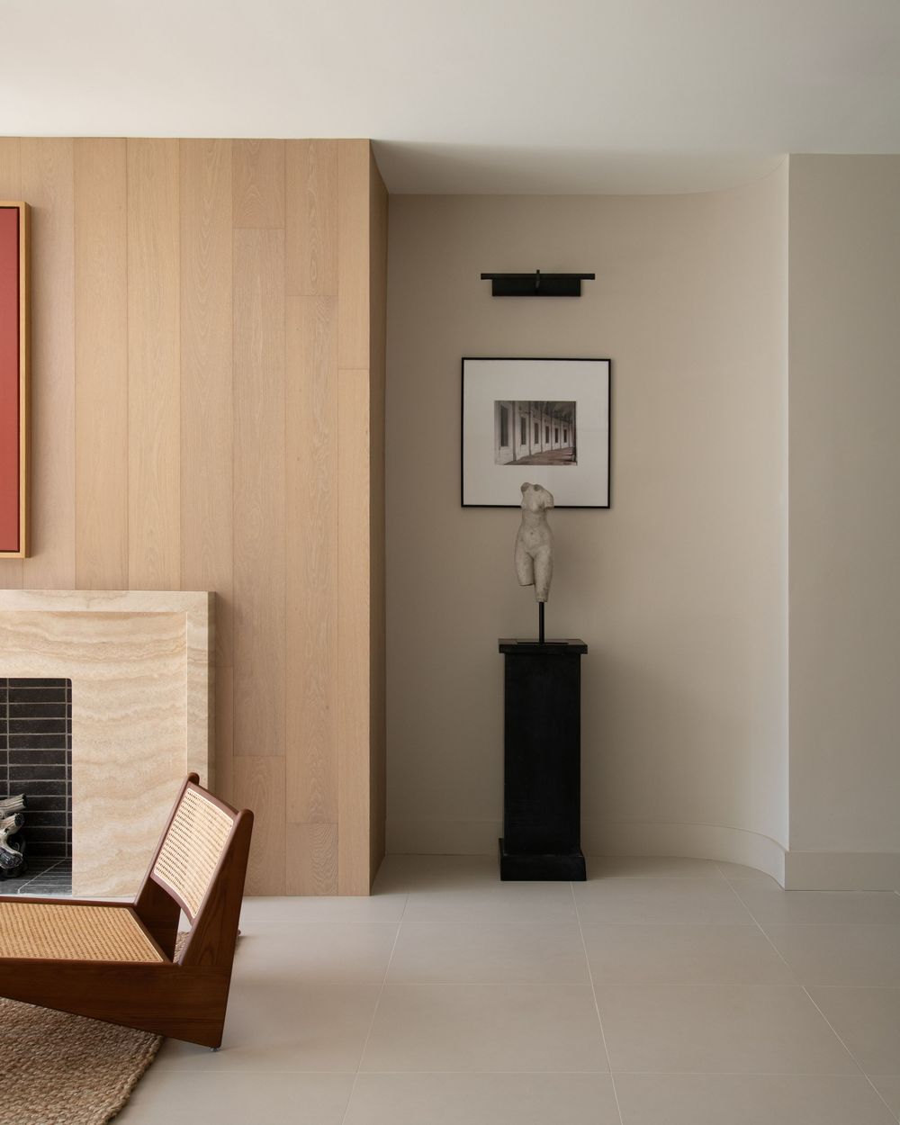 Beige Room with fireplace and black and white photography next to it.