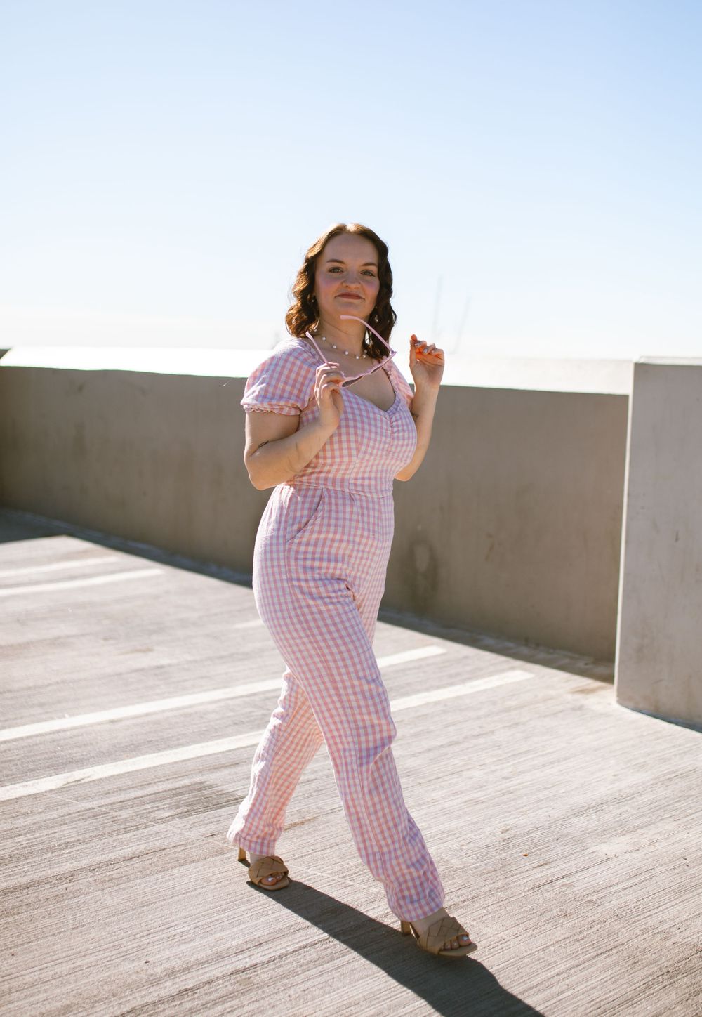 Girl On top of parking garage midday