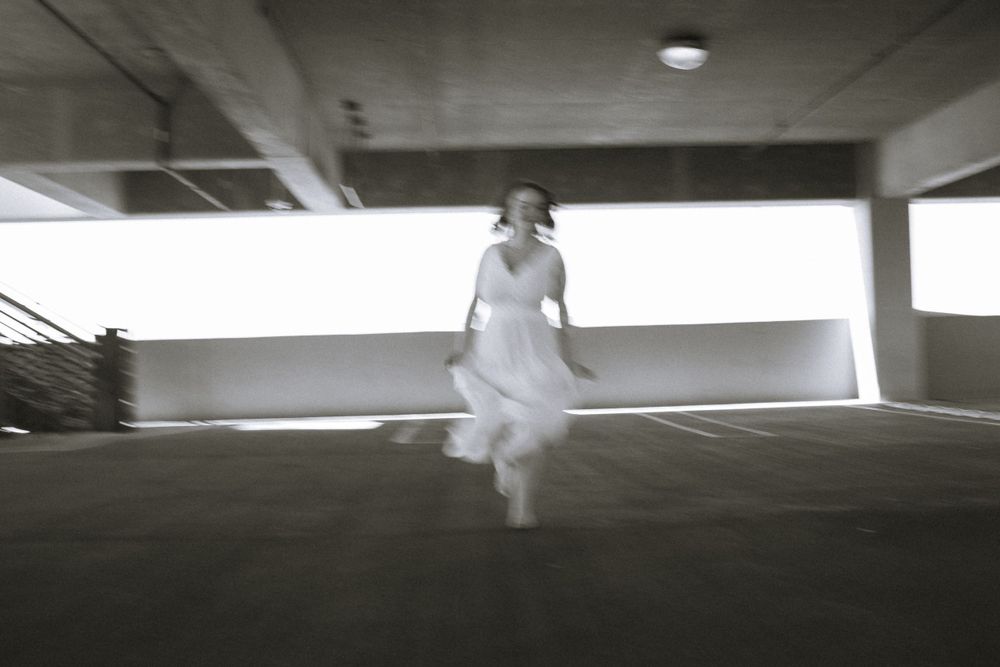 Black and white girl dancing in parking garage