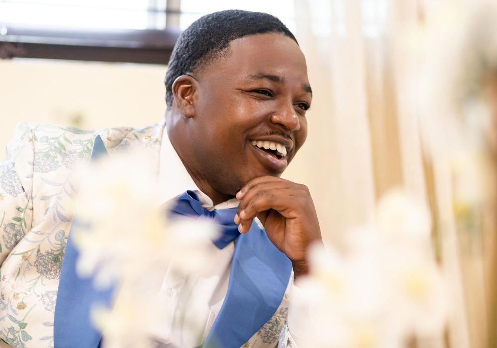 Candid moments of joyful laughter during outdoor wedding celebration.