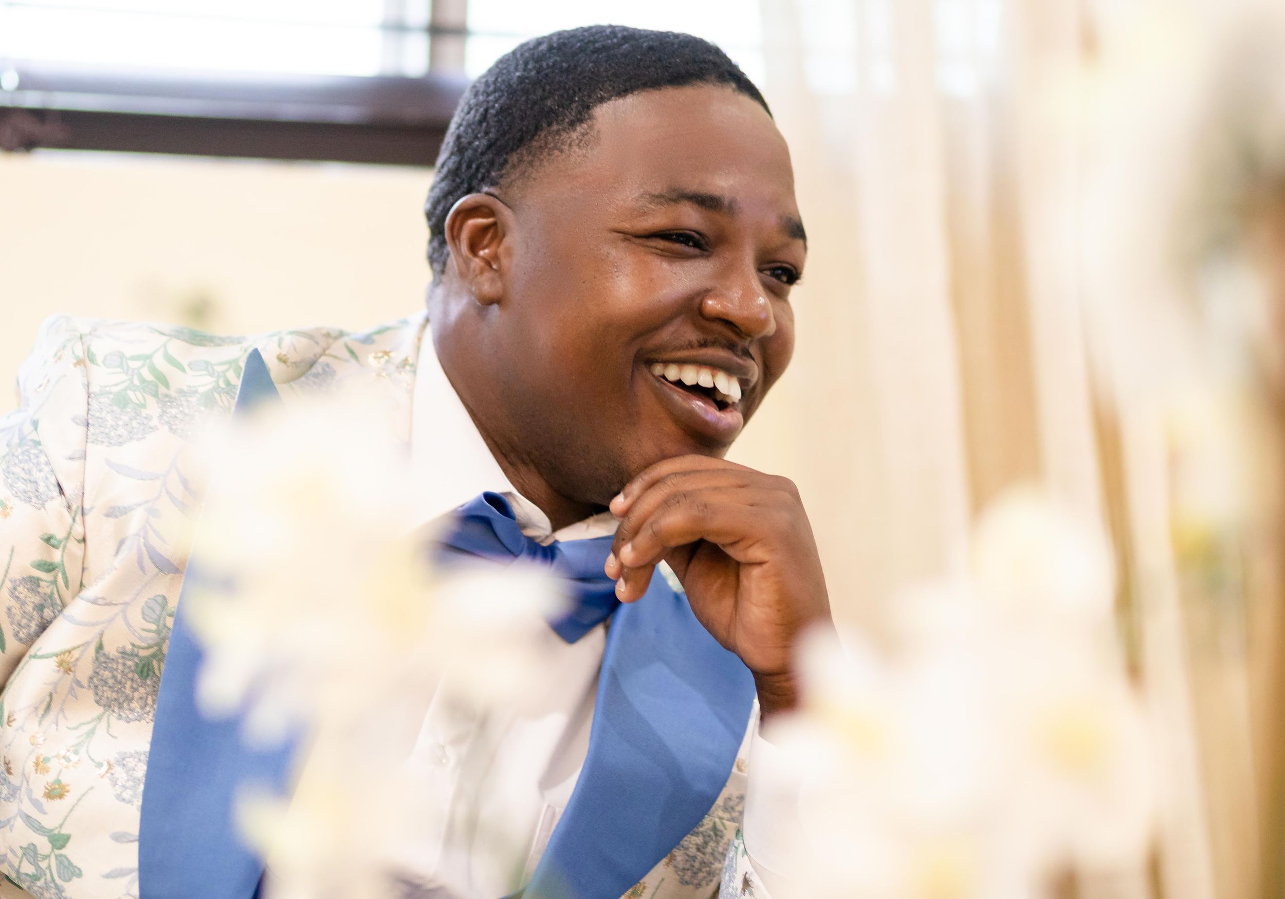 Candid moments of joyful laughter during outdoor wedding celebration.