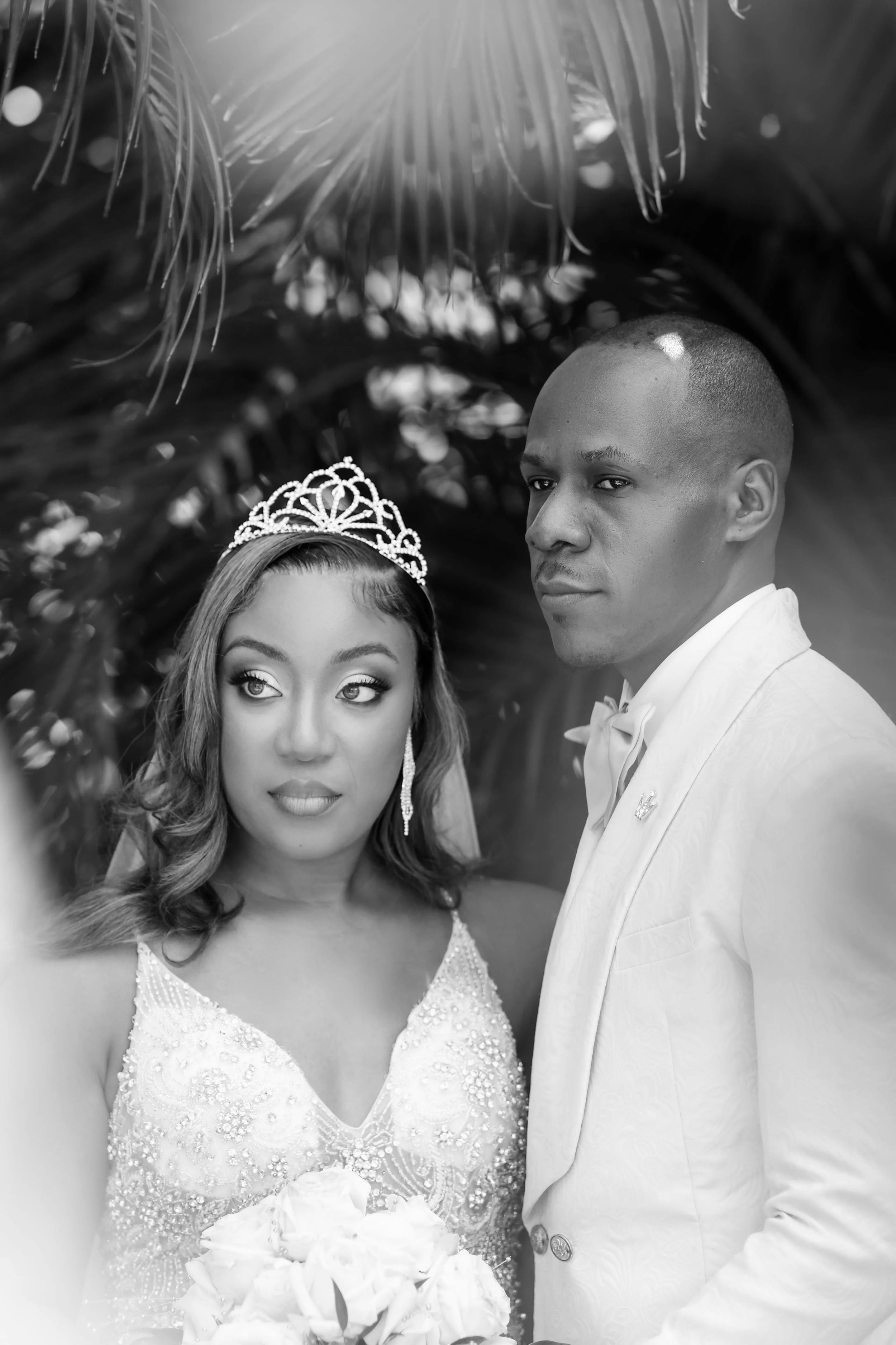 Black and white wedding portraits showing romantic moments between bride and groom.