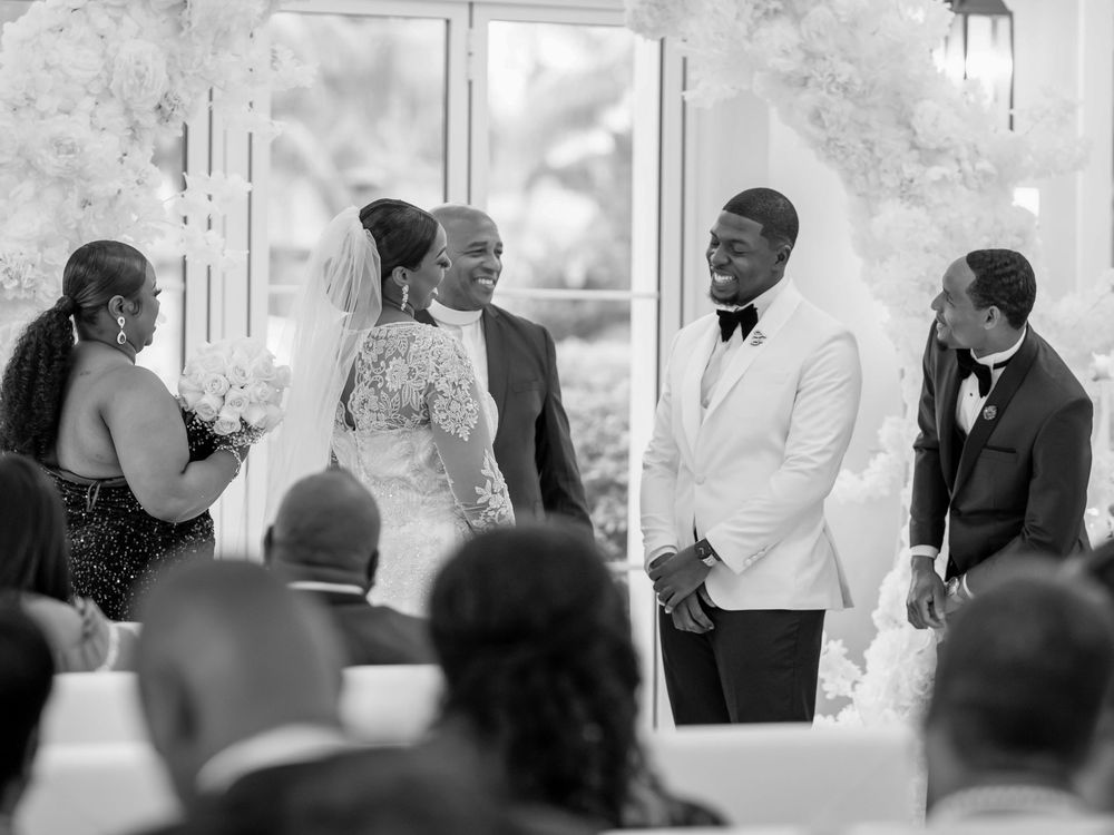 Wedding ceremony guests watching the proceedings in an elegant indoor venue.