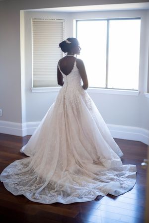 Romantic wedding photography in Orange County featuring a bride and groom embracing during an indoor ceremony. Natural, candid wedding portr
