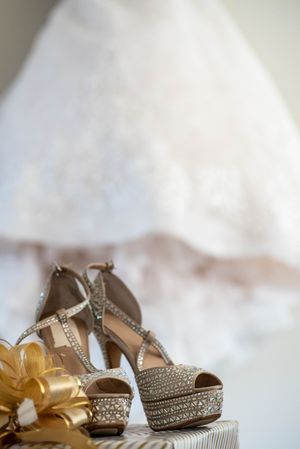 Romantic wedding photography in Orange County featuring a bride and groom embracing during an indoor ceremony. Natural, candid wedding portr
