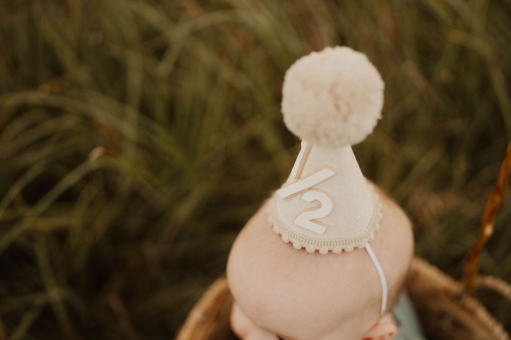 Close-up details of elegant white birthday cake decorations with soft focus.