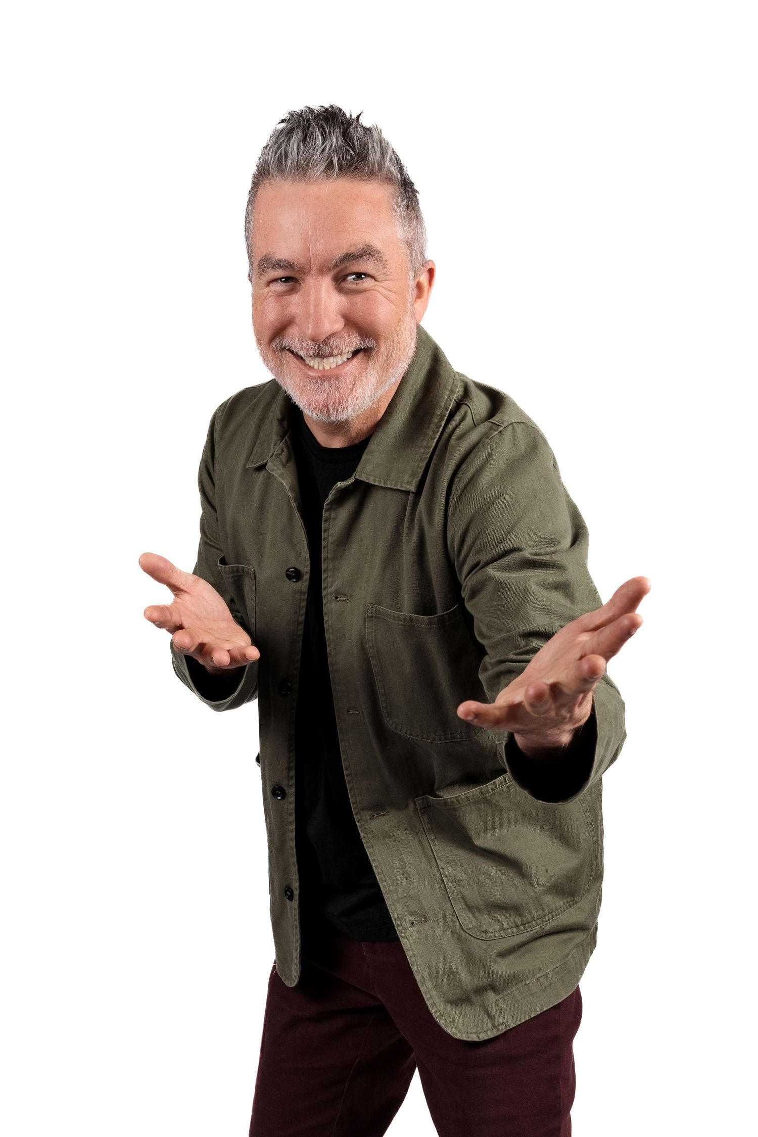Dai Henwood famous New Zealand Comedian smiling at the camera with hands up pointing towards the camera. CL Photography