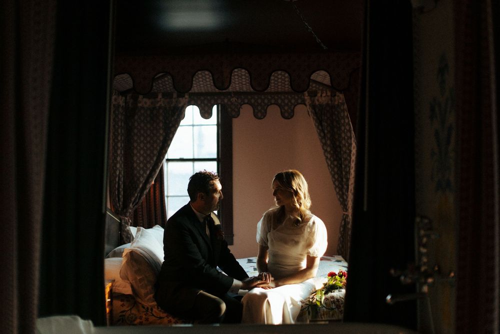 Dimly lit room interior with soft window light filtering through curtains.