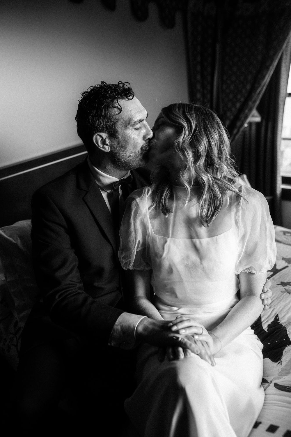 Black and white photos of couple in wedding attire sharing tender moments.