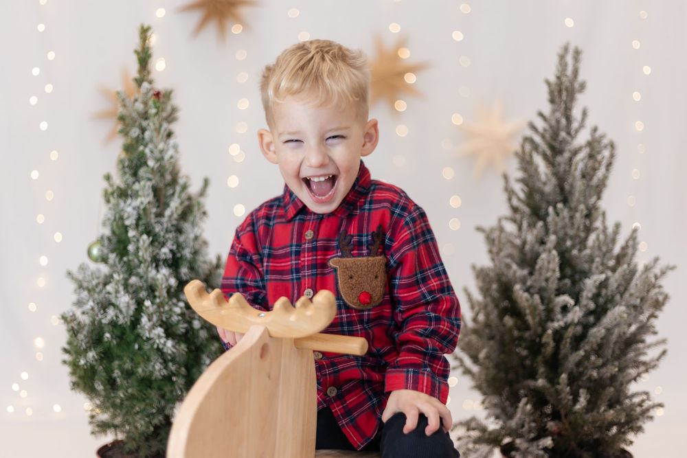 Boy laughing during a christmas photoshoot in Eastbourne