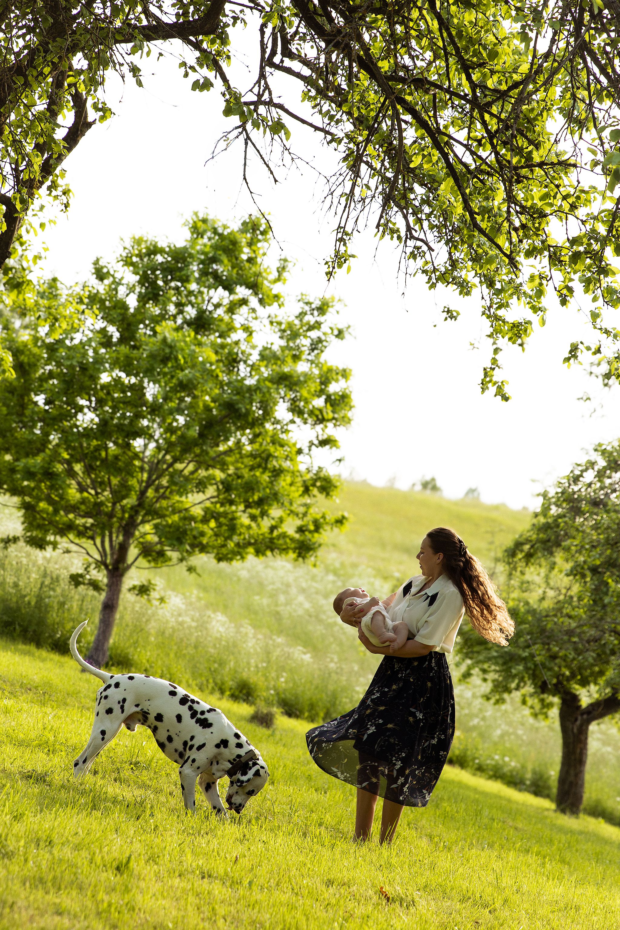 Family photography in Kent with mother, baby and family dog enjoying a relaxed outdoor photoshoot.
