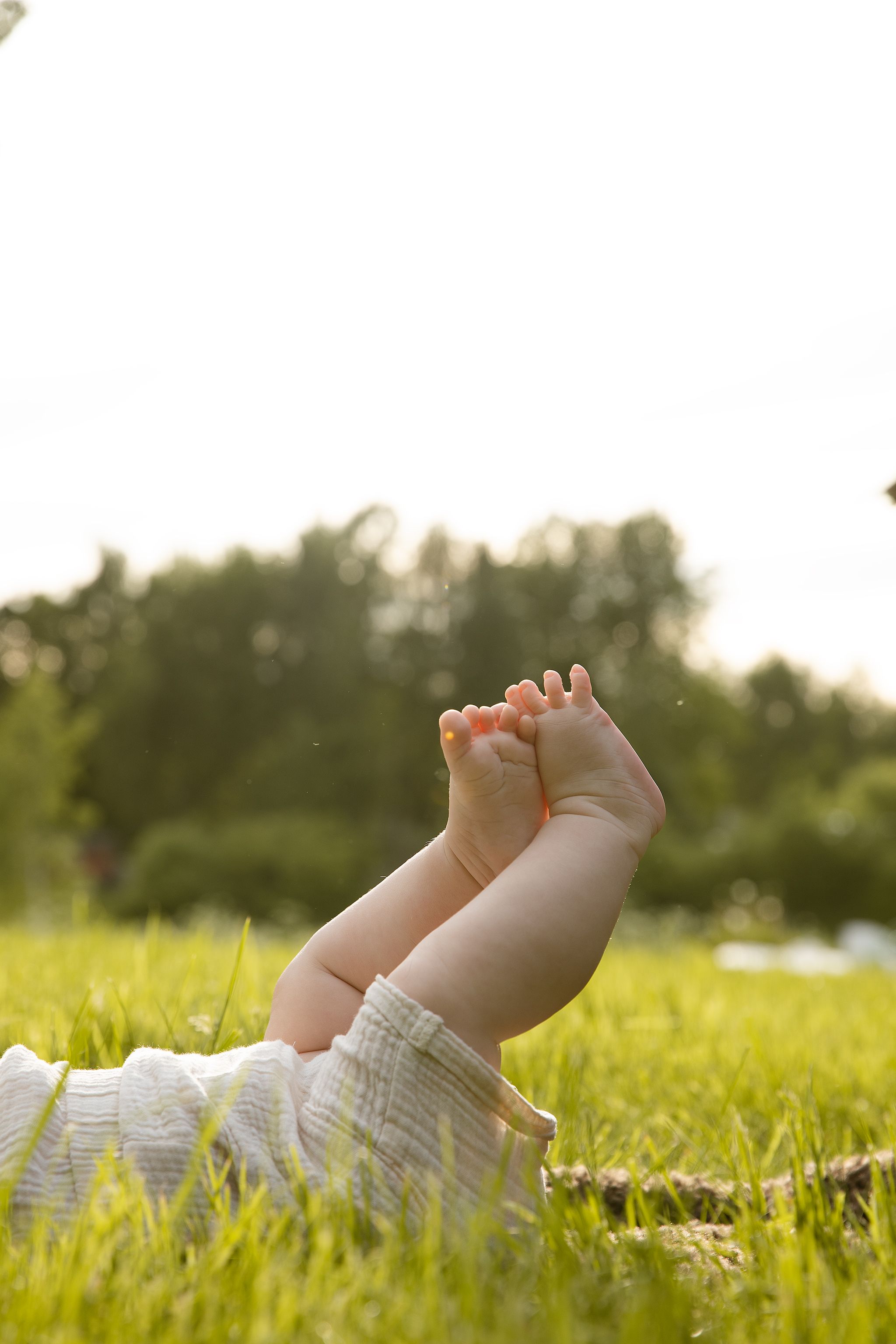 Close-up of baby's feet during an outdoor family photography in Deal, Kent at sunset.