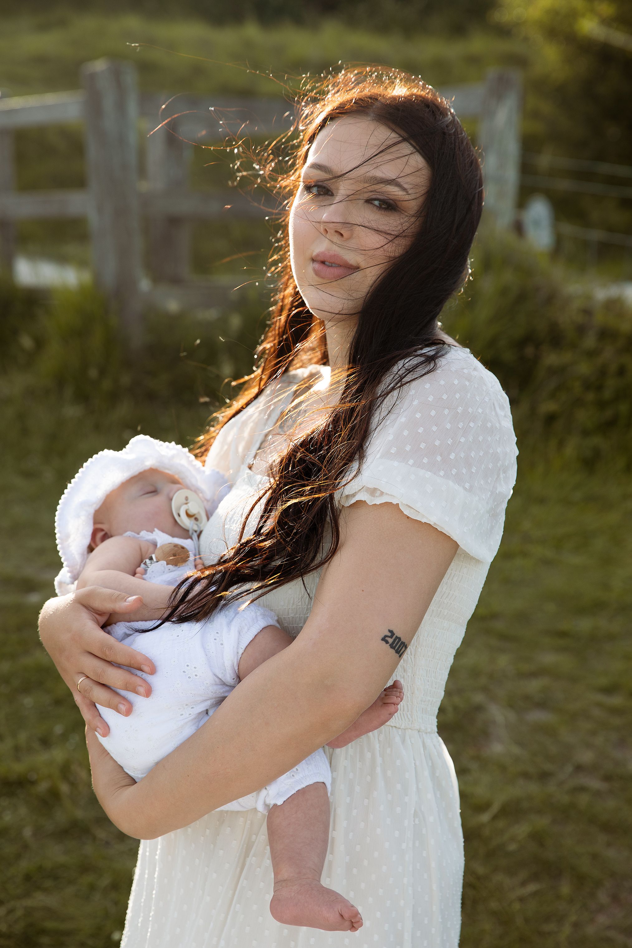 Outdoor motherhood photography session in Kent featuring a mother and a baby enjoying relaxed family photoshoot in a sunset golden hour.