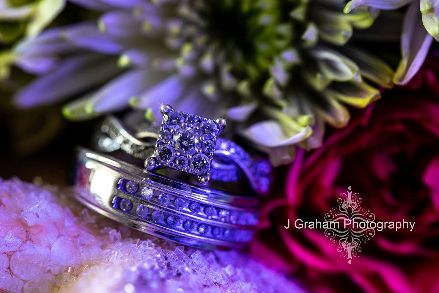 Vibrant purple and pink wedding details with flowers and jewelry captured in artistic macro photography.
